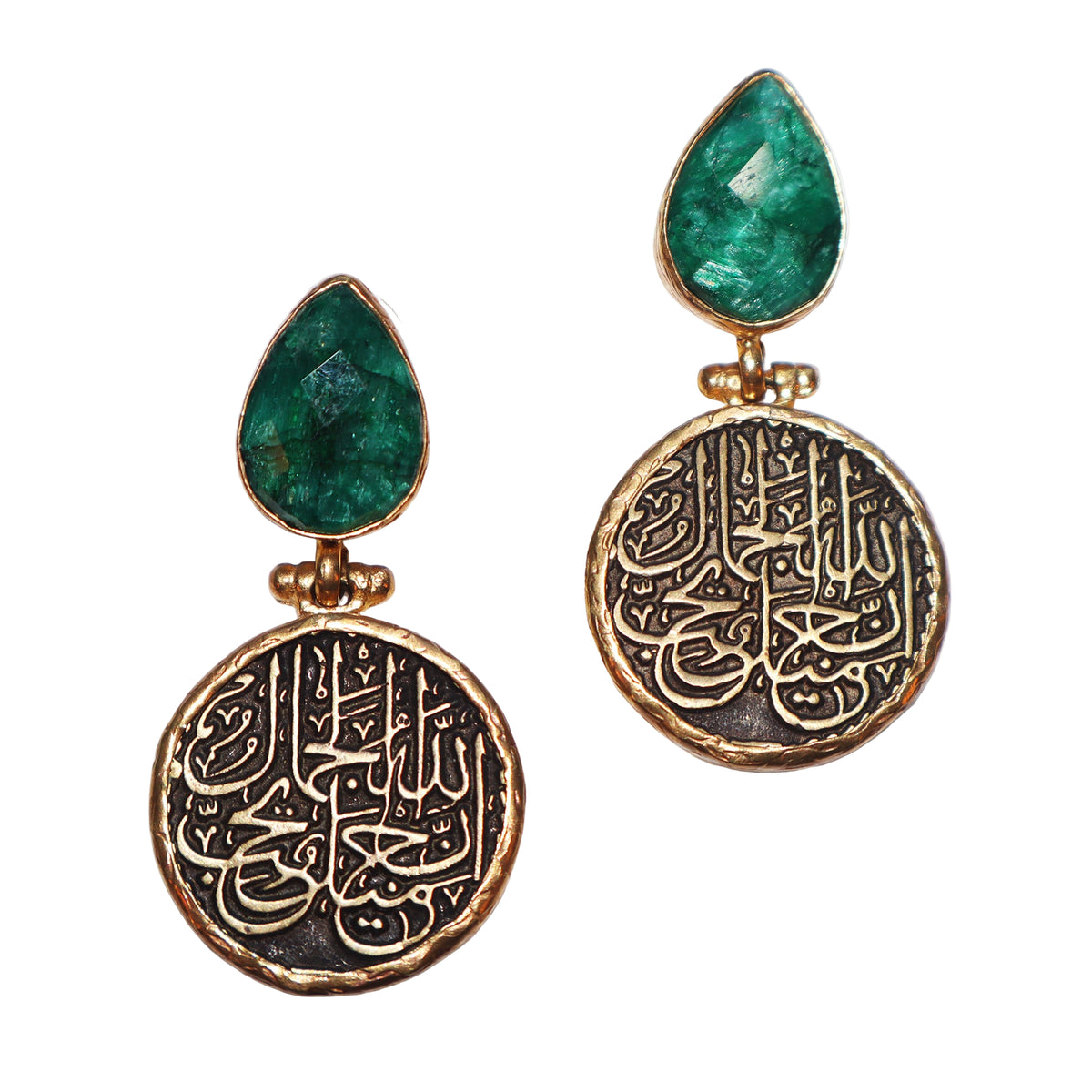 Pair of earrings with green teardrop stones and gold and black circular designs 

